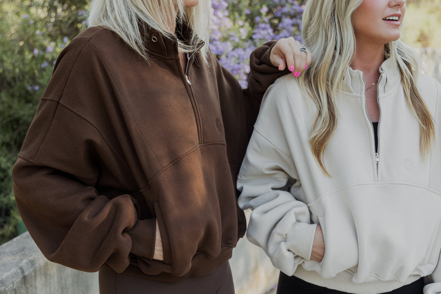 2 white women with blonde hair wearing the same oversized sweaters. This photo is mainly show casing said sweater.