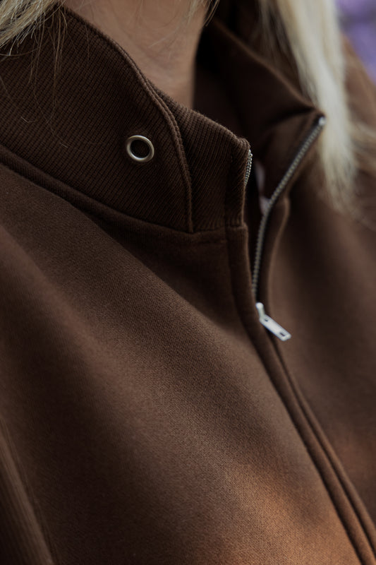 Upclose photo of an oversized cropped quarter sleeve sweater.  this photo is mainly of the color that looks to be flipped up.