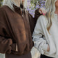 2 white women with blonde hair wearing the same oversized sweaters.  This photo is mainly show casing said sweater.